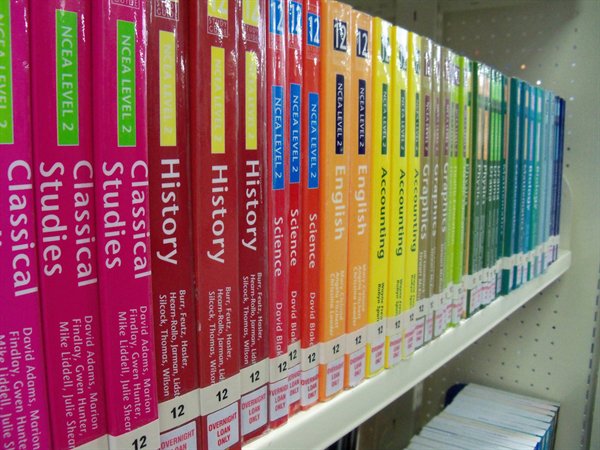 Colorful NCEA Level 2 textbooks on shelf