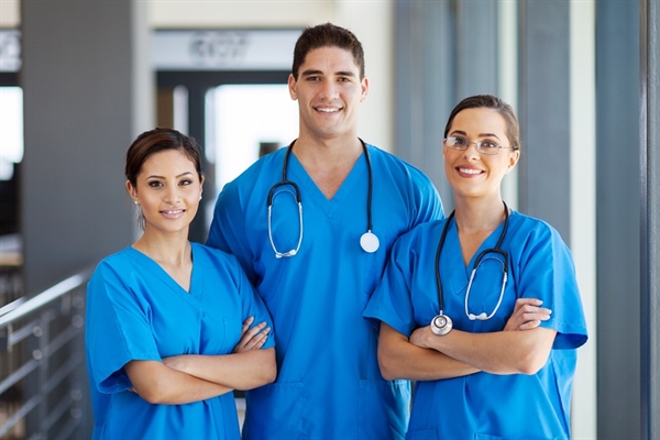 Healthcare professionals in blue scrubs