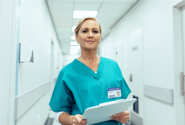 Healthcare professional in hospital corridor