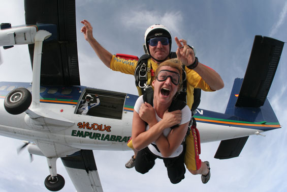 Skydiving tandem jump with airplane backdrop