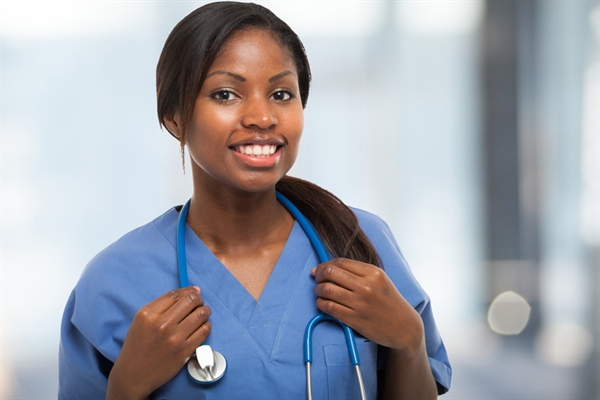 Healthcare professional in blue scrubs indoors